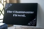 The Champagne flowed photo booth prop and sillent movie board